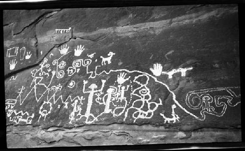 Petroglyph of human and animal figures, handprints