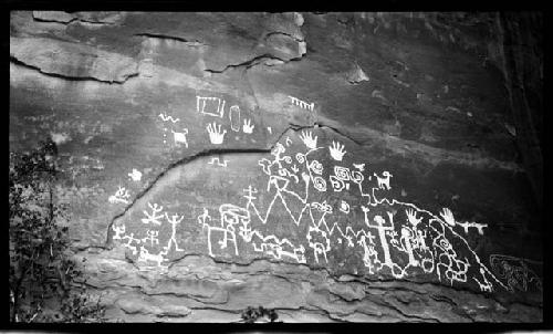 Petroglyph of human and animal figures, handprints