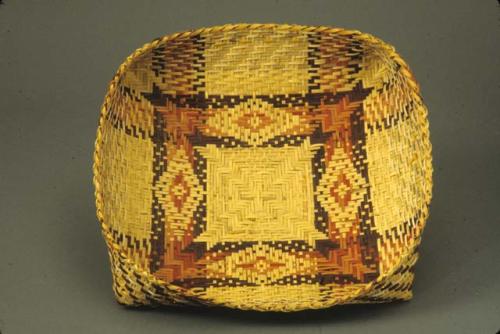 Basketry tray with design inside and outside. Mactis, Nactis, or little fish in