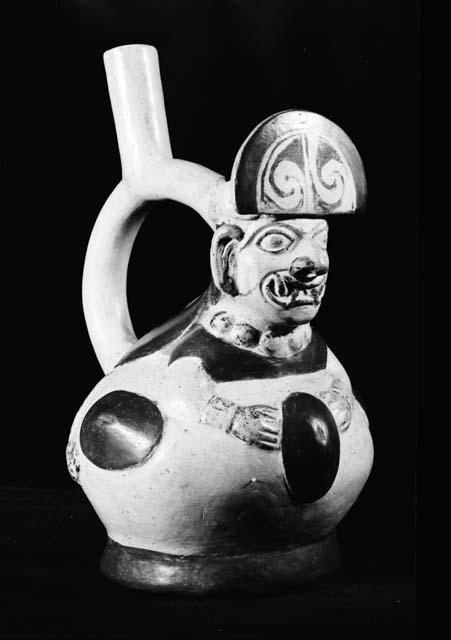 Stirrup vessel, reclining human with fangs and large headdress