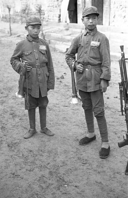 Portraits of two boy soldiers, holding bugles