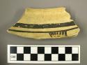 Fragment of black on yellow pottery bowl with 4 rows of tool-marked corrugation
