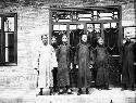Six employees of Chinese firm standing outside building