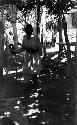 Man sitting under arbor, house courtyard