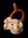 Stirrup-spout vessel in the form of a grotesque face