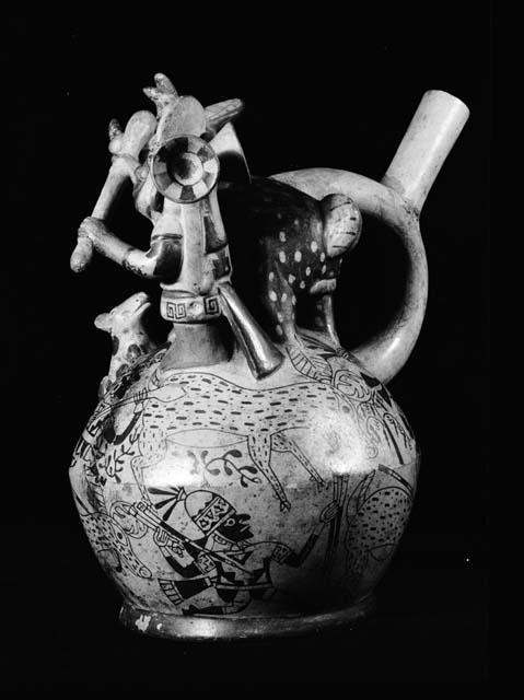 Stirrup vessel, man and dog in relief, hunt depicted on vessel