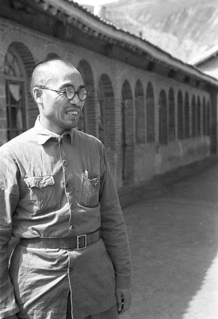 Zhu De (Chu Deh) wearing glasses, standing in front of building