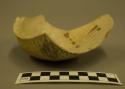 Fragments of pottery bowl--black on yellow inside, corrugated outside