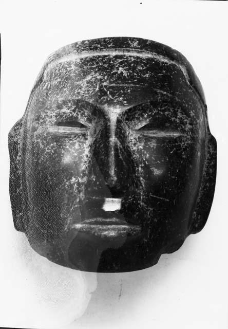 Serpentine mask of a human face