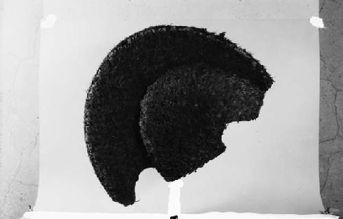 Woven helmet with featherwork covering
