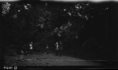 Man and children in jungle