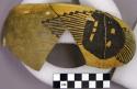 Partial restored black on yellow bowl with outer anthromorph, inner sawtooth