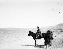 Owen Lattimore with two ponies along Turfan road