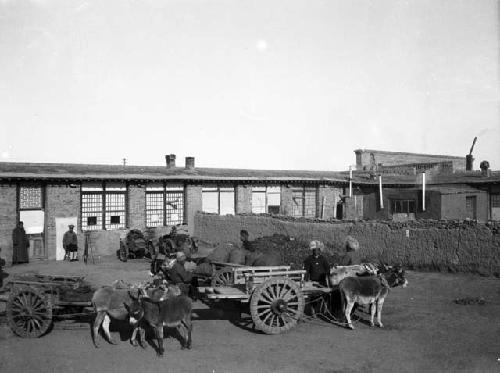 Good view of inn buildings with men and carts in front