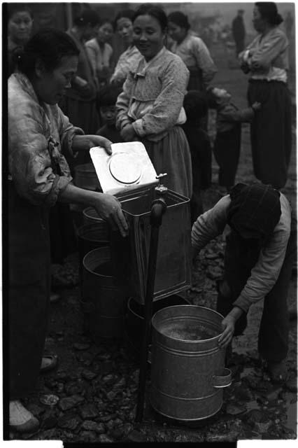 Women filling buckets