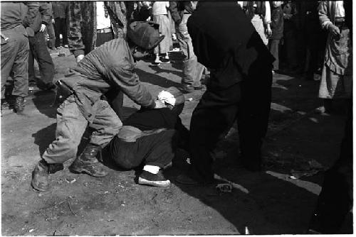 Man being subdued by a police officer