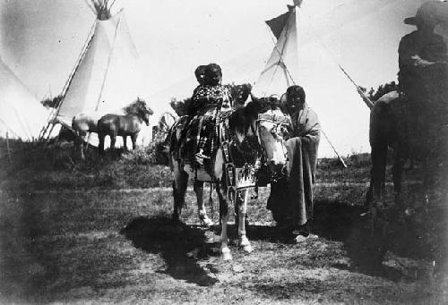 Three Crow Indians on horseback