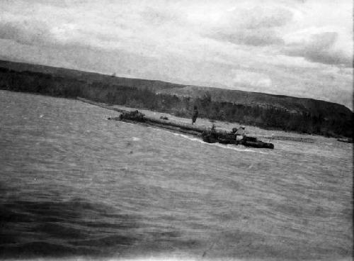 Log raft on Tekkes, being swept downriver with two men