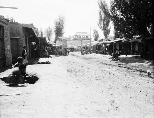 Kulja suburb street scene, buildings, trees, possibly city wall in distance