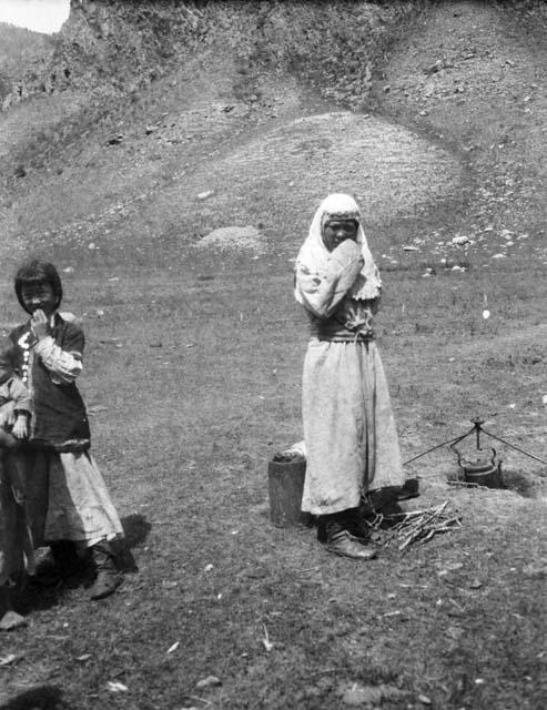 Kazak women and children cooking hole