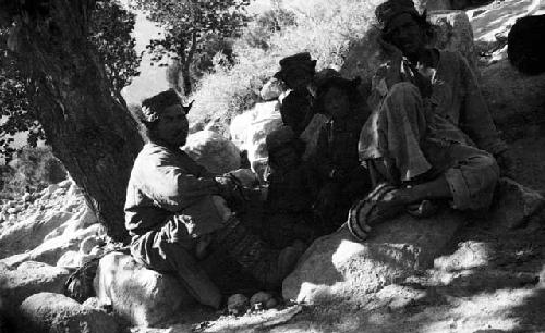 Ladakhi men and children sitting on rocks