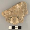 Fragment of a molded flat animal headed pottery figurine