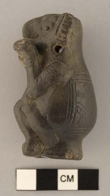 Black seated armadillo effigy rattle eating ear of maize.  Engraved cataphract