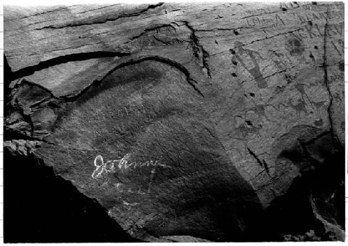 Pecked pictographs above bridge at Moab