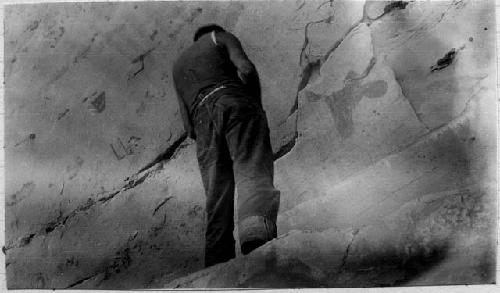 Man standing by ledge just below spring on Kaiparowitz Plateau