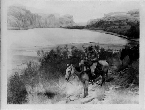 Man on horseback next to river