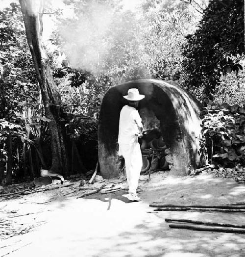 Macedonio Canul loading kiln with wood