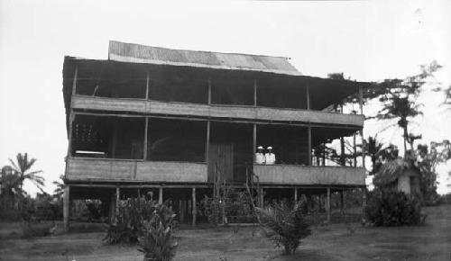 Two women standing in the new mission house, Sapo, Pudu clan