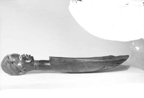 Large wooden ladle with carved head handle