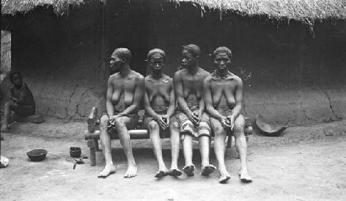 Four women in mourning on bench displaying hair style