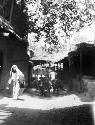 Women walking along lane, donkeys