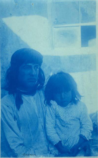 Man with small girl on lap, Acoma