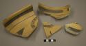 Fragments of black-on-yellow pottery bowl