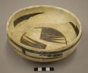 Black on yellow pottery bowl