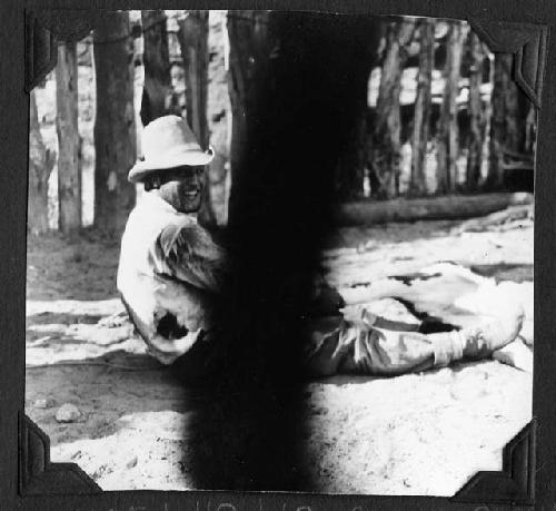 Man sitting by calf