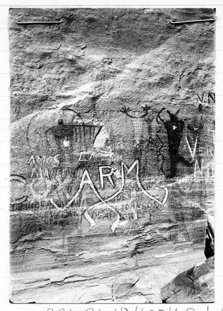 Pictographs, Man under rainbow holding sign