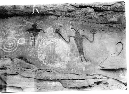 Petroglyph, two men in red paint circle in white paint