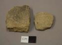 Earthenware body sherds, shell tempered, one undecorated, one cord impressed