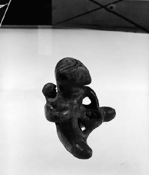 Figure of woman with child on back and vessel in front