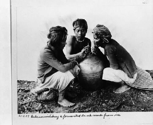 Subanos imbibing a fermented drink made from rice