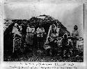 Eskimo women and children in front of hut