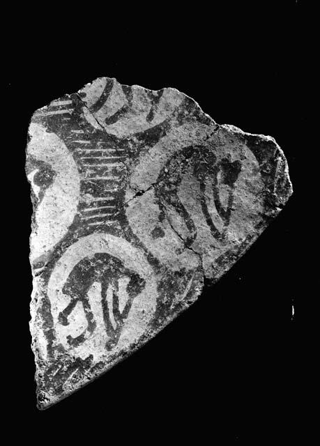 Red-on-buff rim potsherd, flute-player decoration