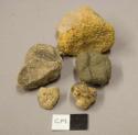 Stones, likely non-cultural; earthenware fragment, unfired, likely raw material; soft pliable material, possibly clay
