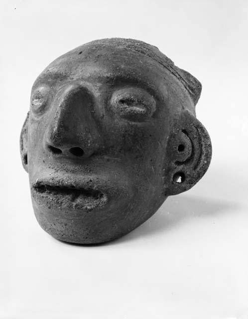 Photo of Las Mercedes red human effigy head