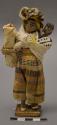 Doll, woman with baby and roll of woven plant fiber, affixed to stand