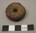 Amber spindle whorl, discoidal with incised rings on one side